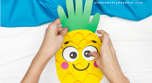 hand gluing stem to handprint pineapple