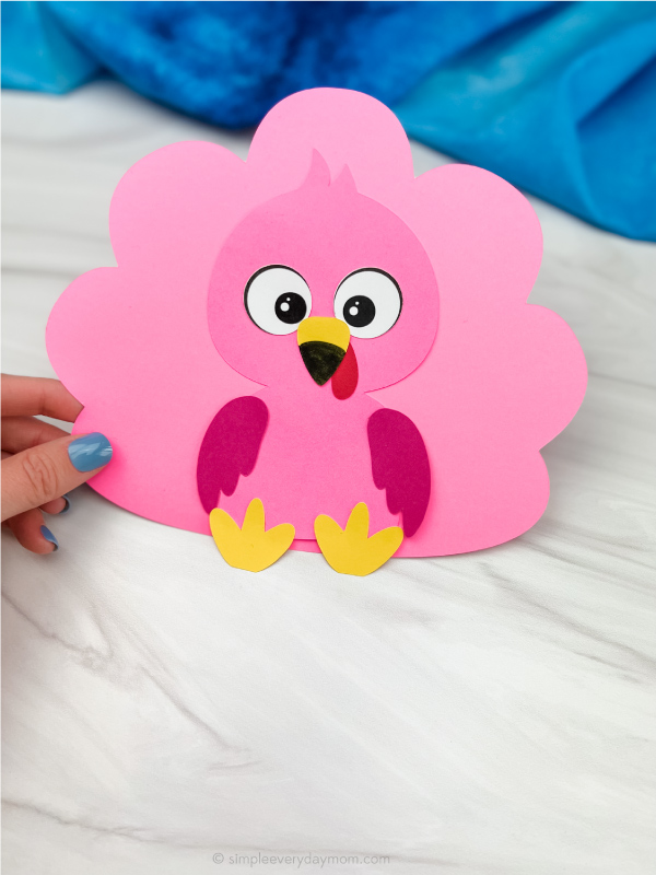 hand holding flamingo turkey in disguise craft
