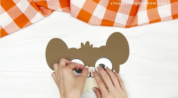 hands gluing nose on mouse pumpkin craft