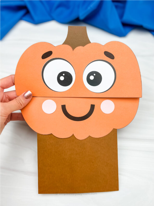 hand holding pumpkin paper bag craft