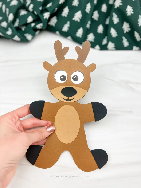 hand holding reindeer gingerbread man in disguise craft