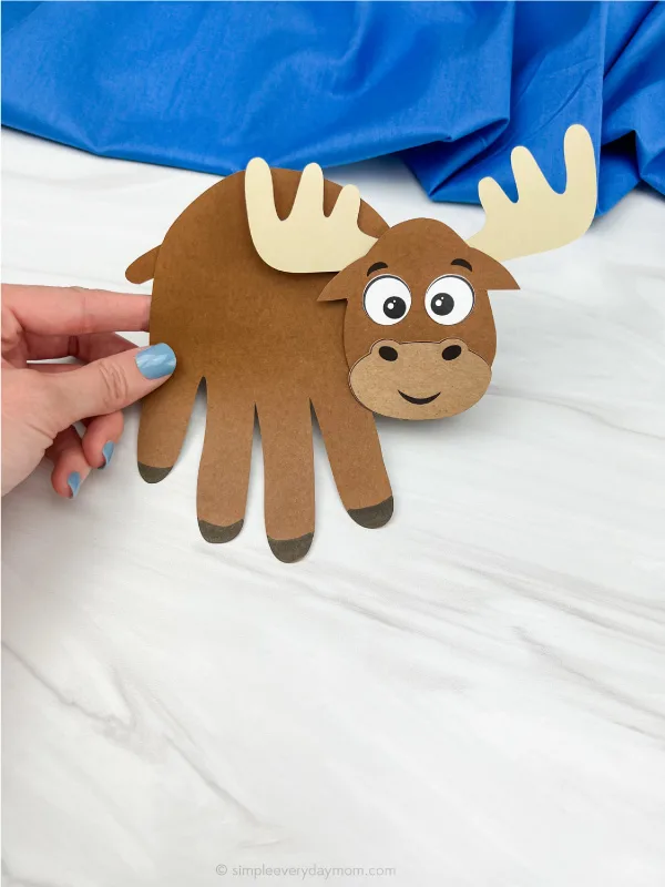 hand holding moose handprint craft