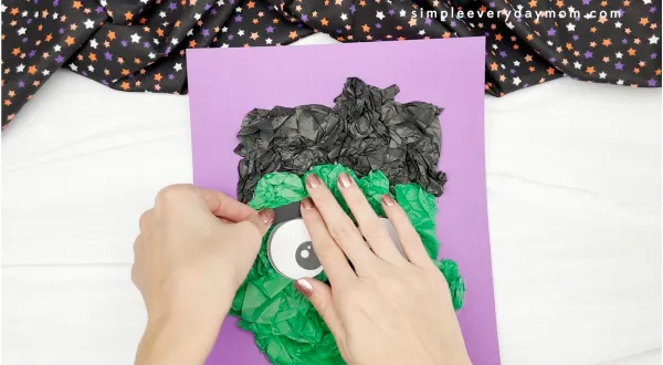 hand gluing eyebrows to Frankenstein tissue paper craft