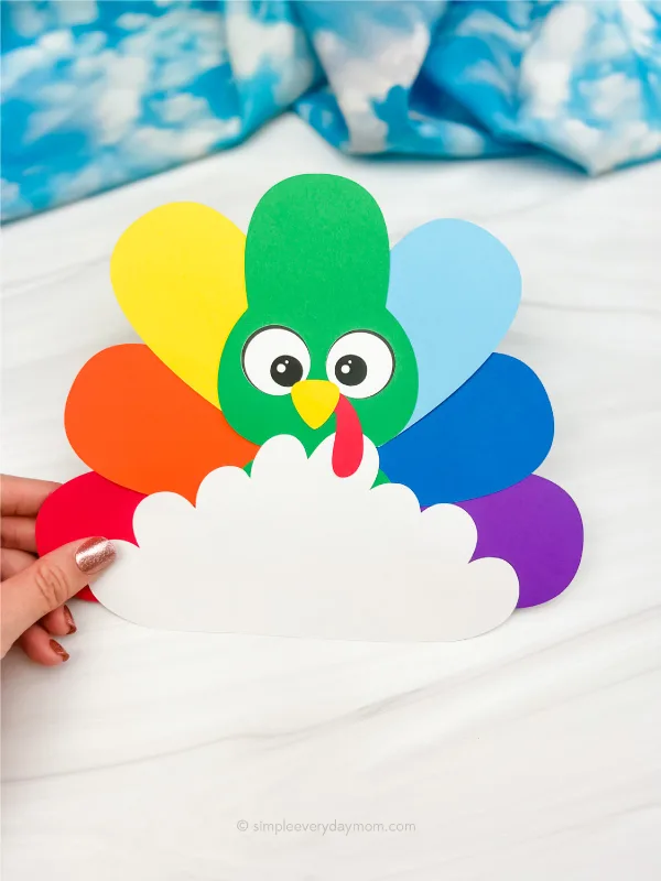 hand holding rainbow disguise a turkey craft