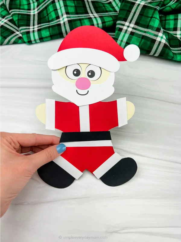 hand holding Santa disguise a gingerbread man craft
