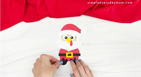 hand gluing feet to Santa turkey disguise craft