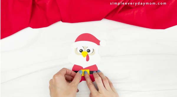 hand gluing buckle to Santa turkey disguise craft