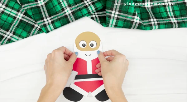 hands gluing beard to Santa gingerbread man disguise craft