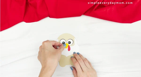 hand gluing beak to Santa turkey disguise craft