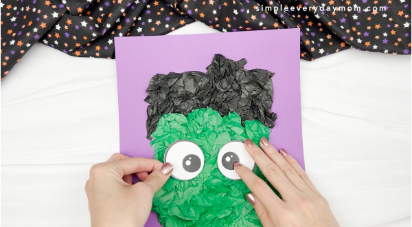 hand gluing eye to Frankenstein tissue paper craft