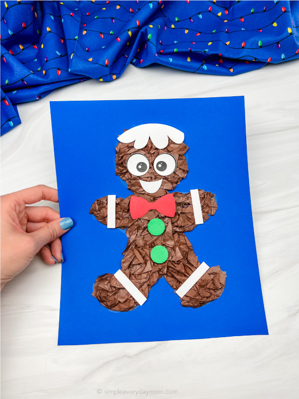 hand holding tissue paper gingerbread man craft