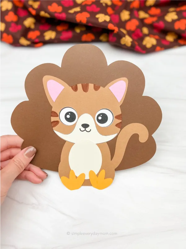 hand holding cat turkey in disguise craft