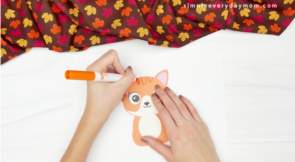 hand drawing stripes onto turkey in disguise cat craft
