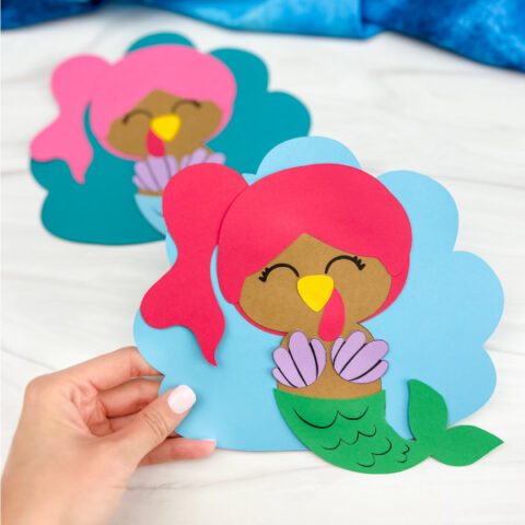 hand holding mermaid turkey disguise craft with another one in the background