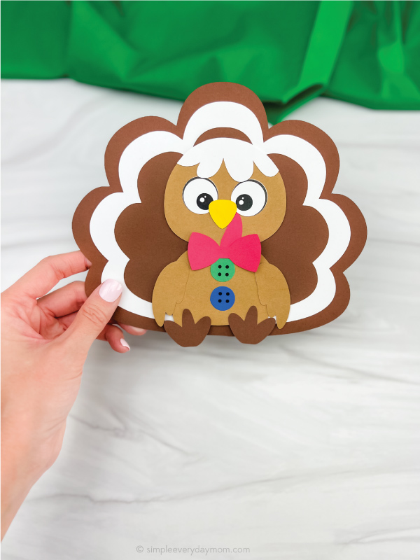 hand holding gingerbread man turkey disguise craft