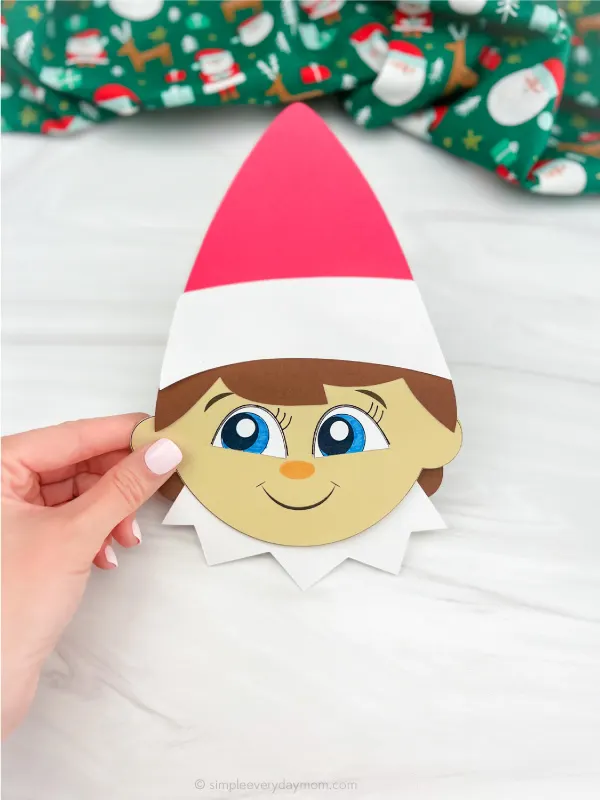 elf on the shelf paper craft being held to display