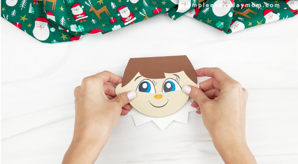 hand assembling elf face onto collar