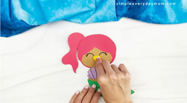 hands gluing beak to mermaid turkey disguise craft