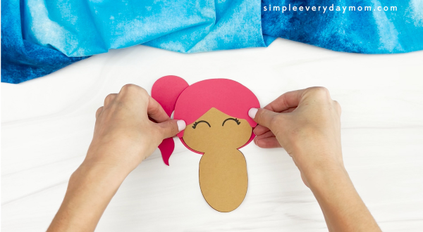 hands gluing back of hair to mermaid turkey disguise craft