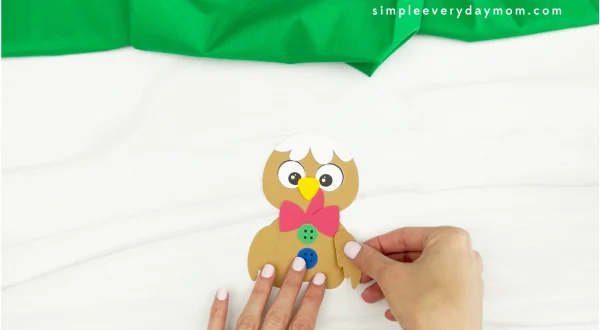 hands gluing wings to gingerbread turkey disguise craft