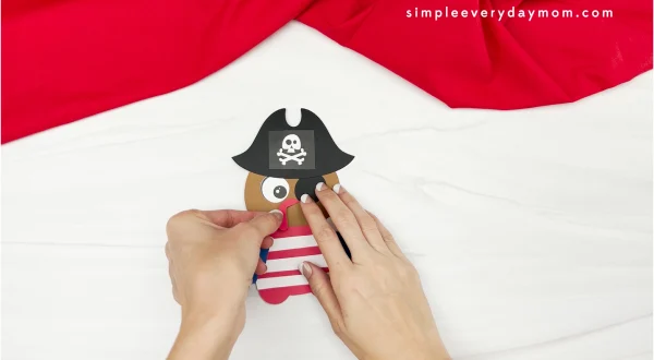 hands gluing snood to pirate turkey disguise craft
