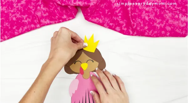 hand gluing crown to princess turkey disguise craft