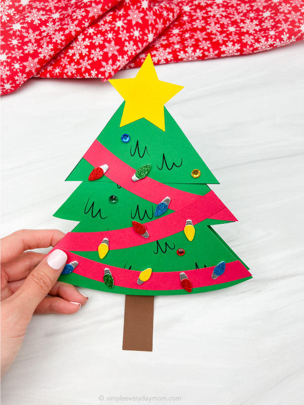 hand holding Christmas tree card craft