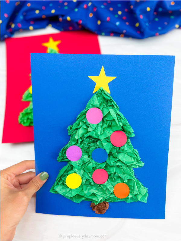 hand holding finished Christmas tree tissue paper craft
