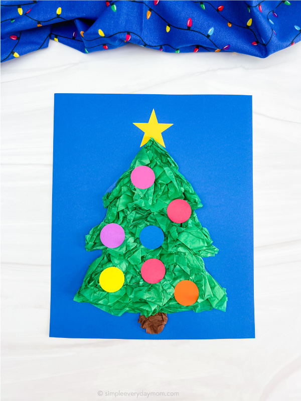 finished Christmas tree tissue paper craft with blue background