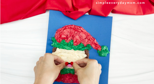 hand is placing mouth on the elf tissue paper