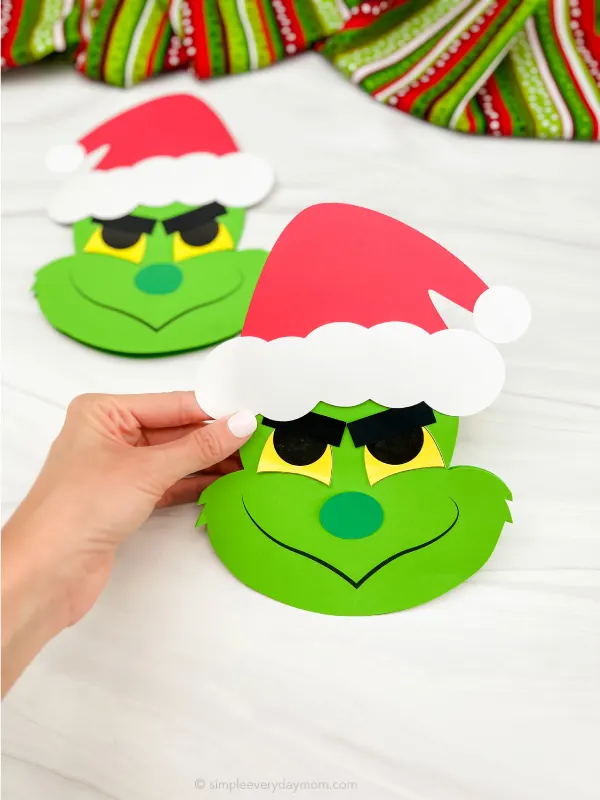 hand holding Grinch card craft with a 2nd craft in the background