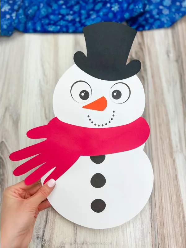 hand holding handprint snowman craft