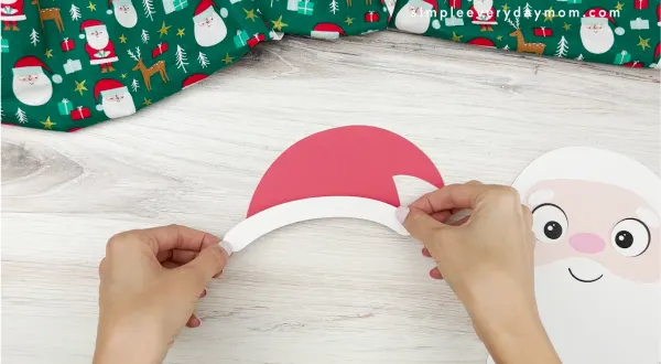 hands assembling santa hat for santa name craft