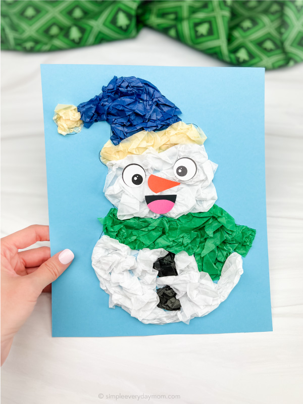hand holding tissue paper snowman craft
