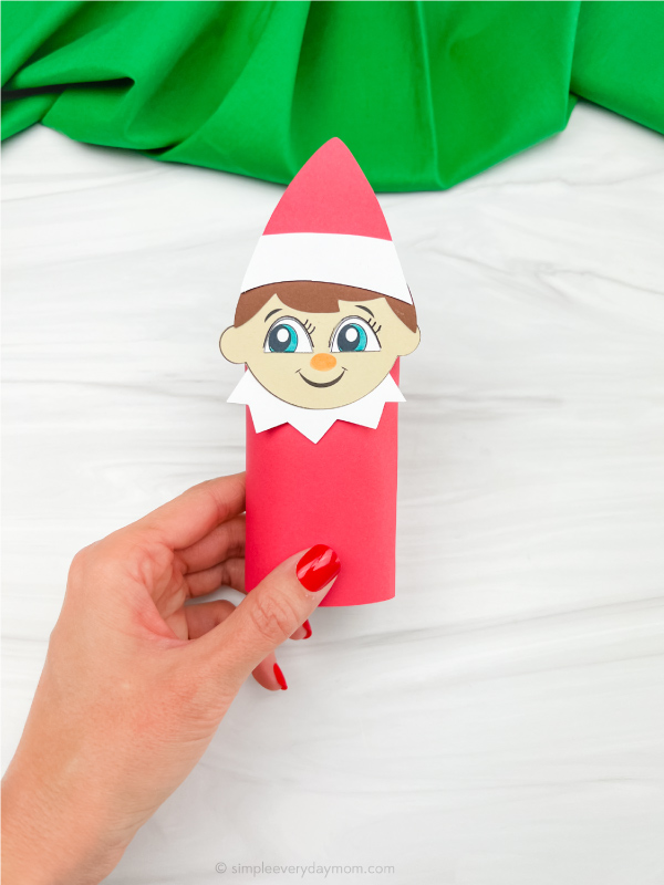 hand holding finished elf on the shelf toilet paper craft