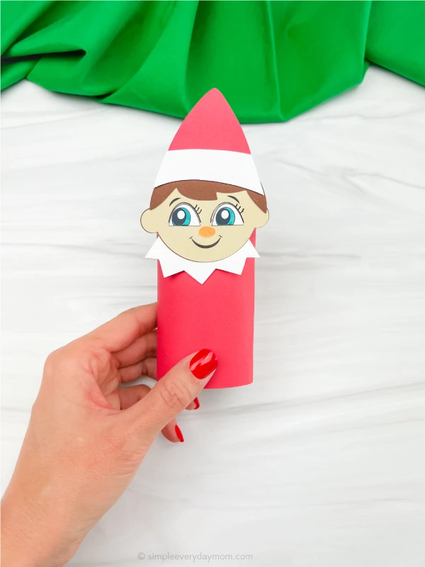 hand holding finished elf on the shelf toilet paper craft