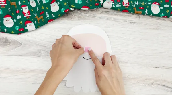 hand placing nose on face of santa name craft