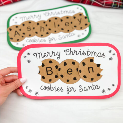 hand holding Santa's cookie plate name craft with a second one in the background