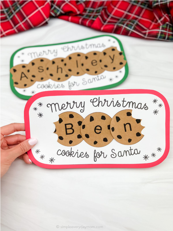 hand holding Santa's cookie plate name craft with a second one in the background