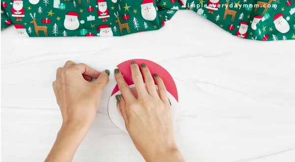 hands assembling Santa's hat