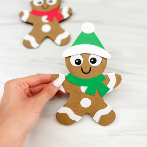 hand holding gingerbread man card craft with another one in the background