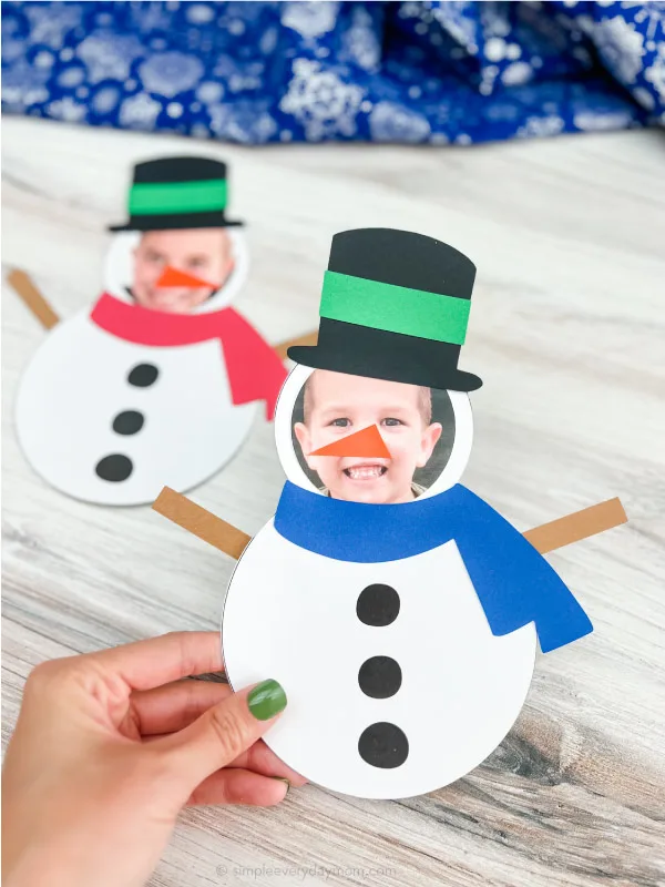 Hand holding finished snowman photo craft