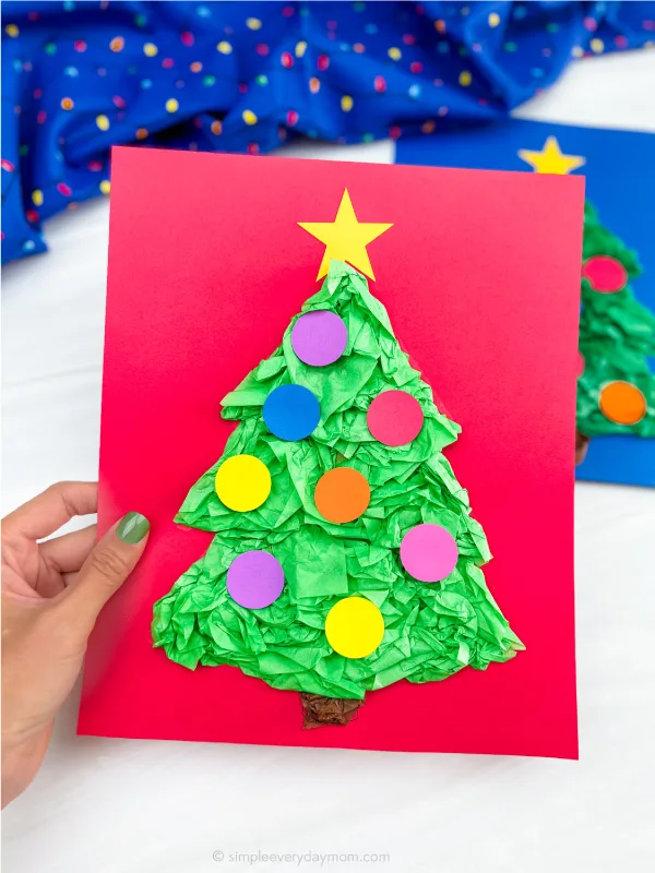 hand holding finished Christmas tree tissue paper craft