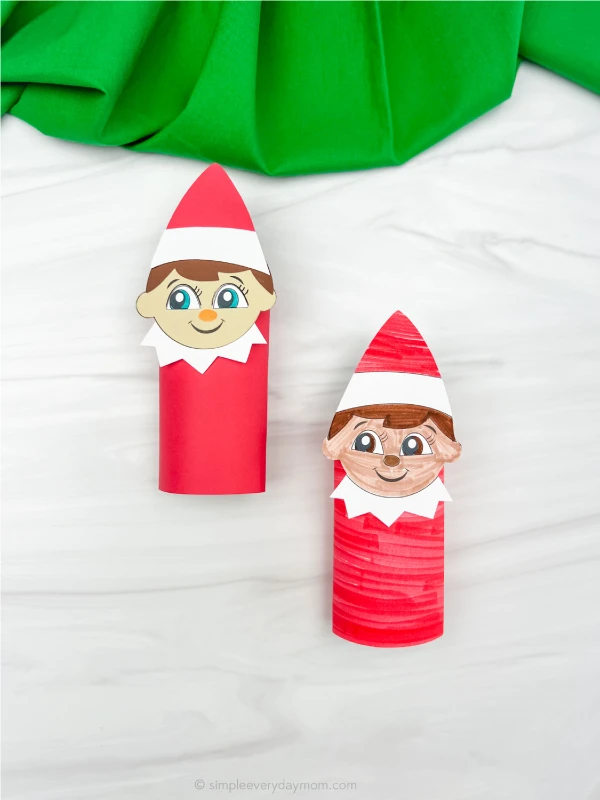 two finished elf on the shelf toilet paper roll crafts, side by side one a little offset from each other