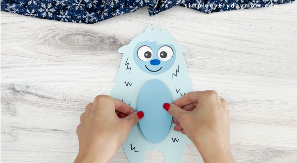 hands gluing belly to abominable snowman craft