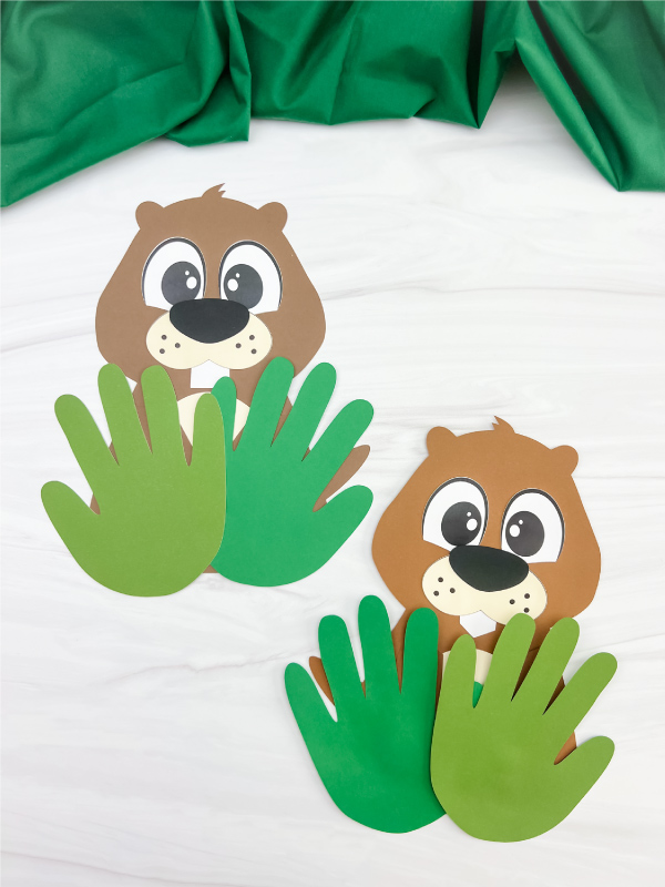 two versions of finished examples of groundhog handprint craft