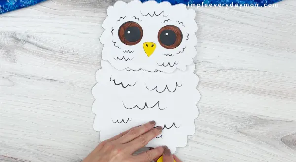 hands gluing feet to owl babies puppet craft