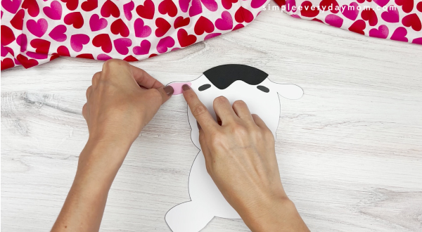 hands assembling ear for cow valentine craft
