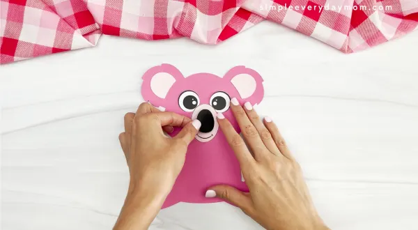 hands assembling nose of koala valentine craft