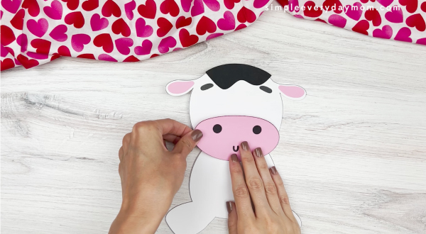 hands assembling nose for cow valentine craft